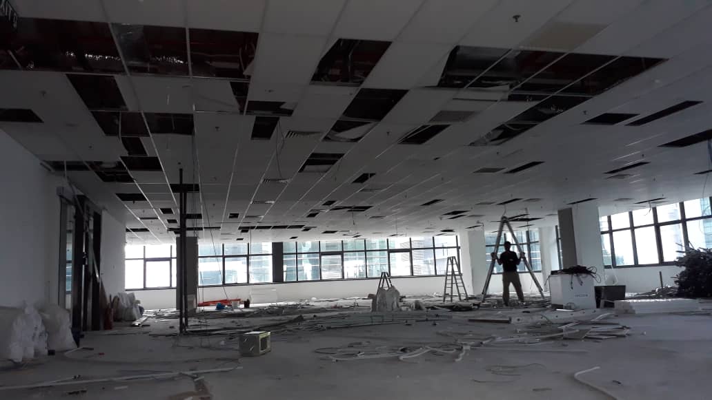 Singapore office mid-reinstatement with ceiling tiles and partitions removed — Shieldguard end-of-lease reinstatement