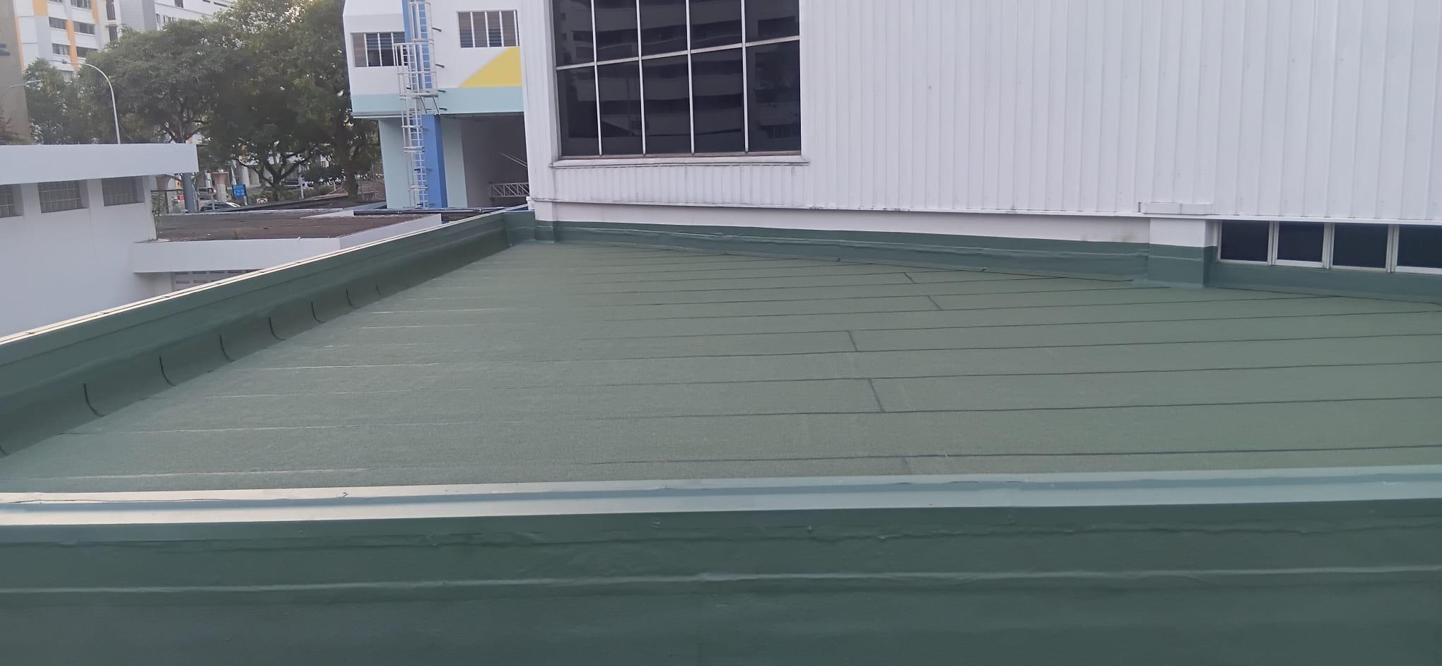Green polyurethane (PU) liquid waterproofing membrane on a flat RC roof with sealed parapet upstands at a Singapore commercial property