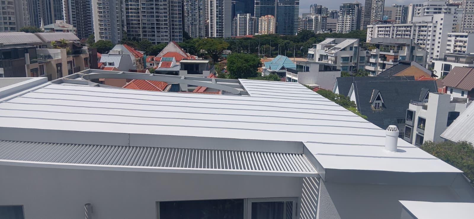 Freshly waterproofed white metal rooftop on a Singapore landed home with the city skyline in the background — Shieldguard rooftop coating project