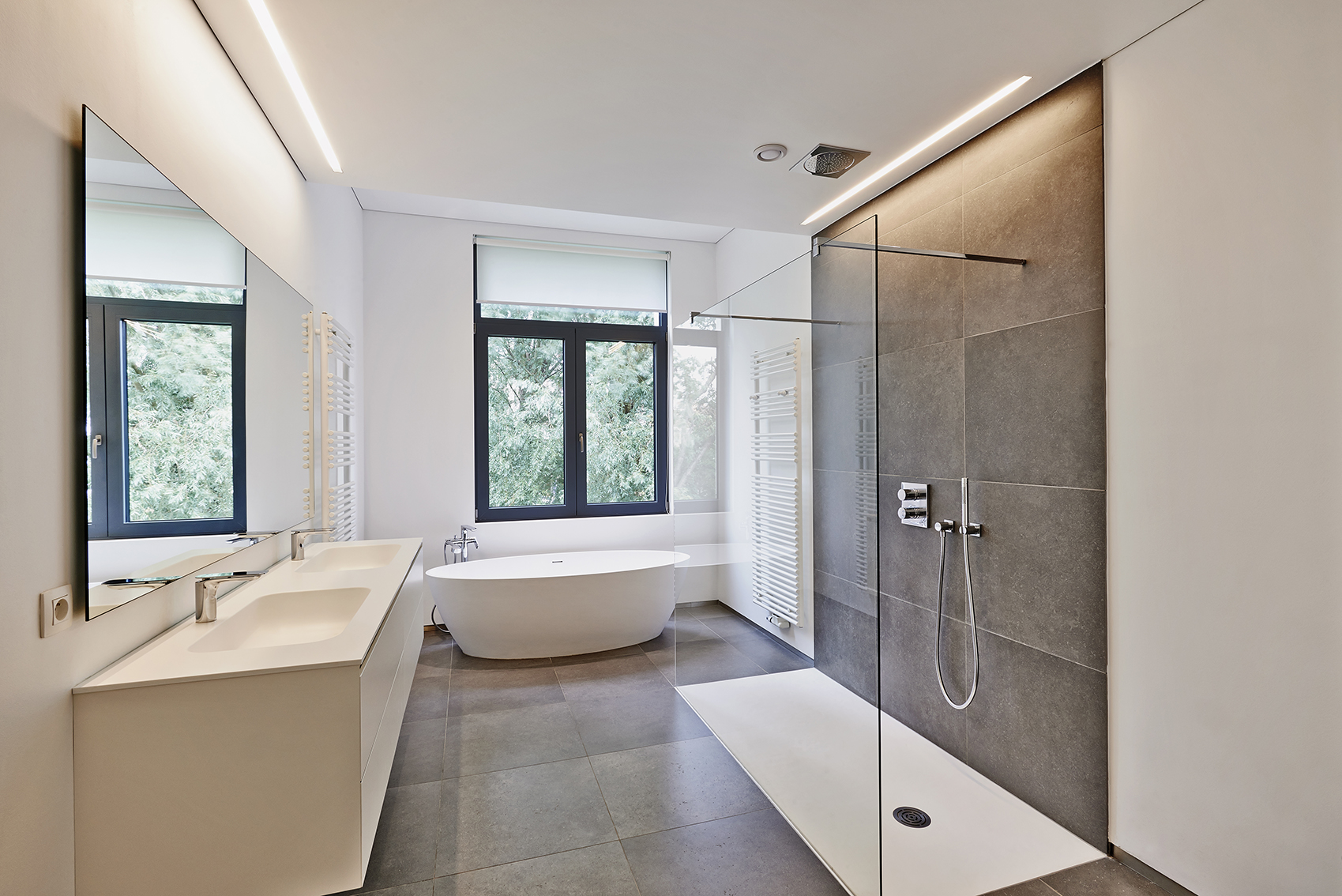 Modern Singapore bathroom with walk-in shower and freestanding tub — fully waterproofed wet-area system by Shieldguard