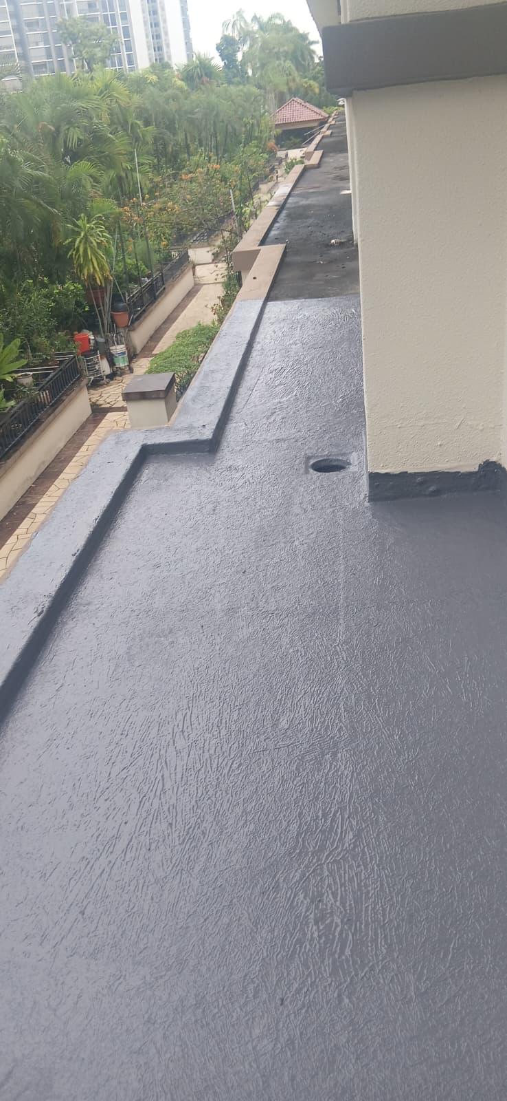 Grey PU liquid waterproofing membrane applied to a horizontal concrete slab with drain outlet in Singapore